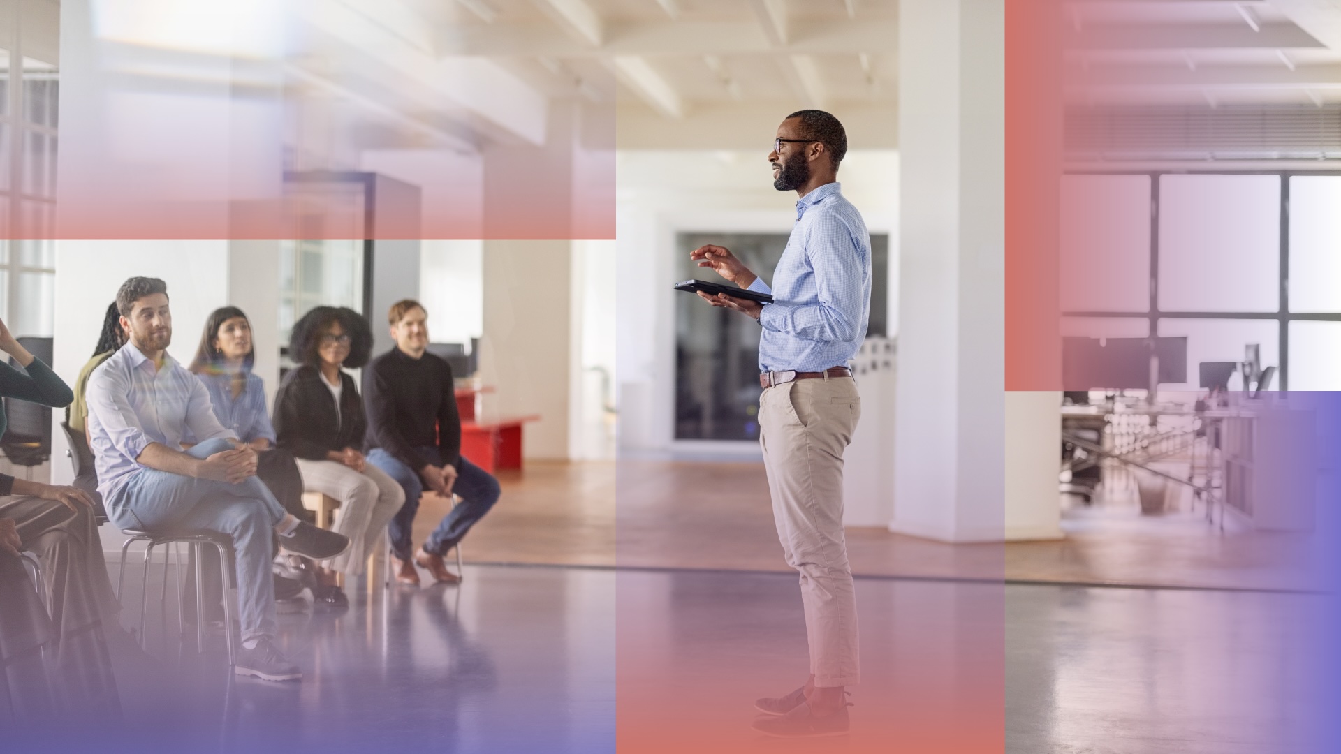 Man giving a presentation to a crowd of office employees