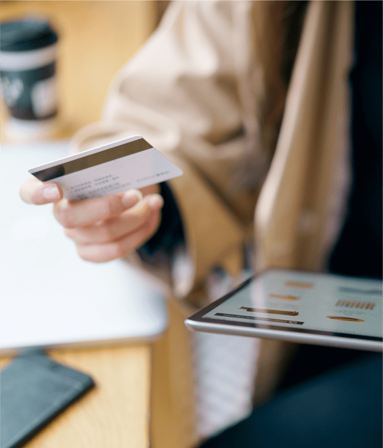 Close-up of woman holding an iPad and credit card